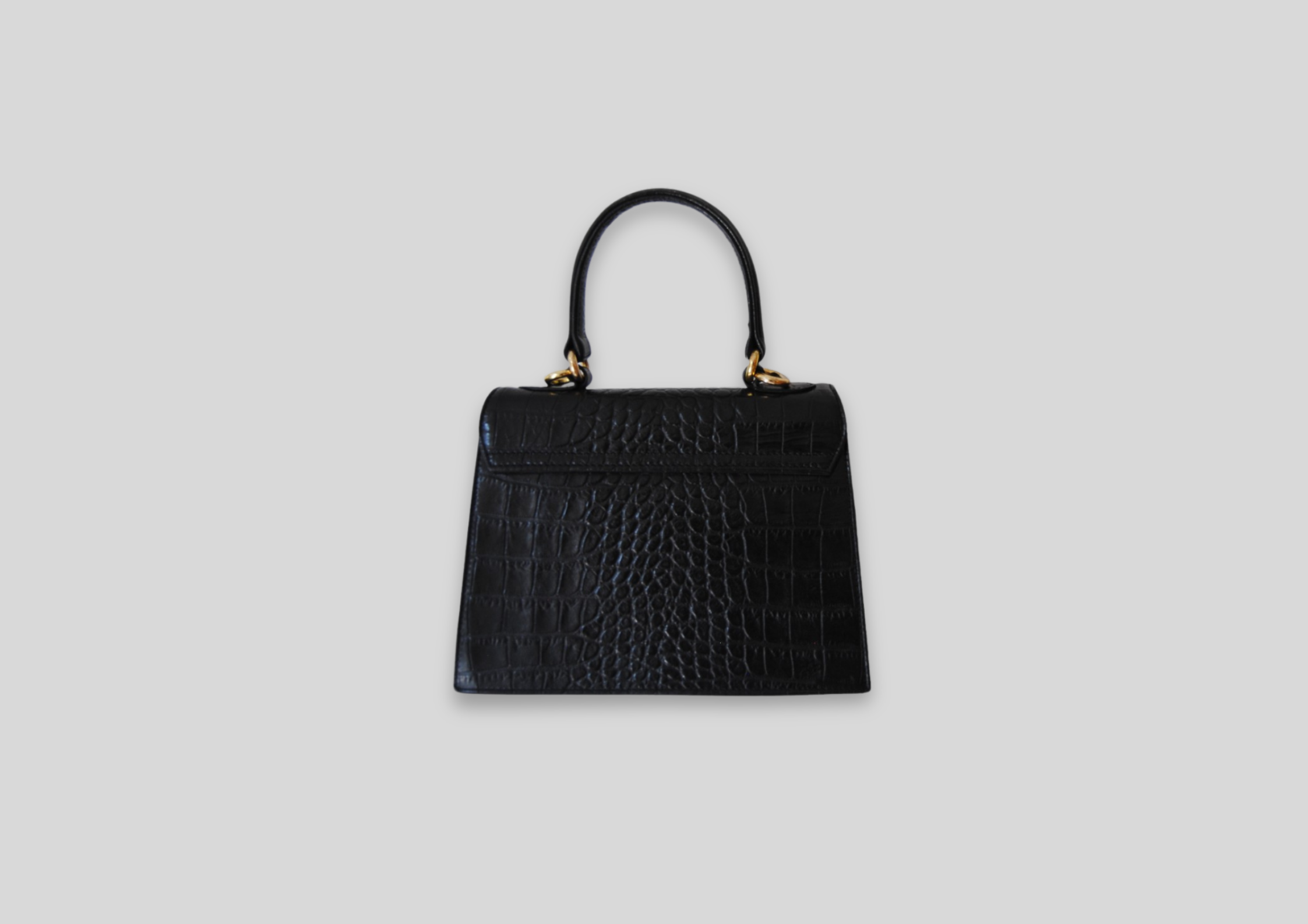 Black crocodile leather handbag with structured design and elegant top handle. Perfect for luxury handbag enthusiasts.