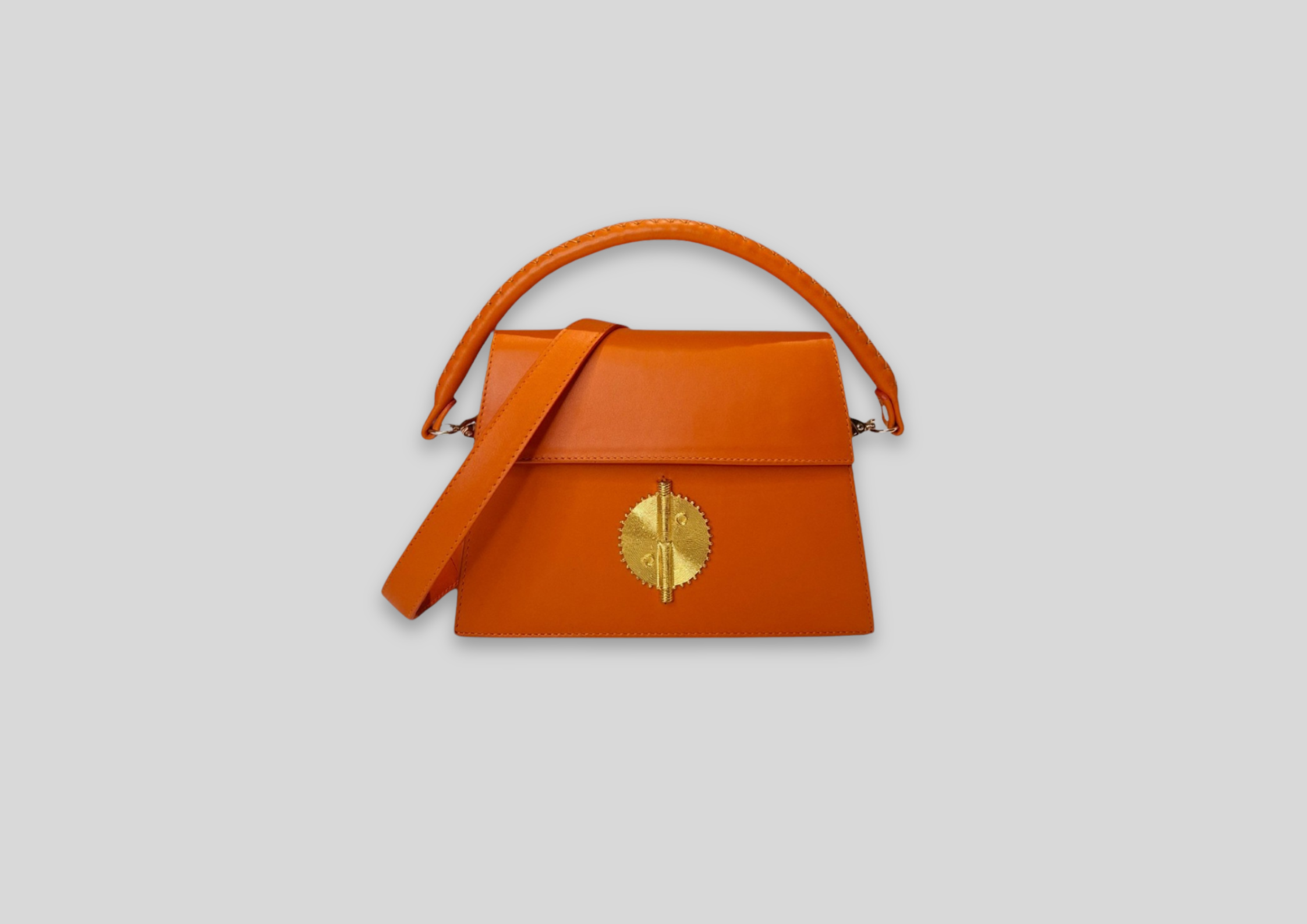 Malaika Bag in vibrant orange with gold detail, a luxurious and stylish accessory for any occasion.