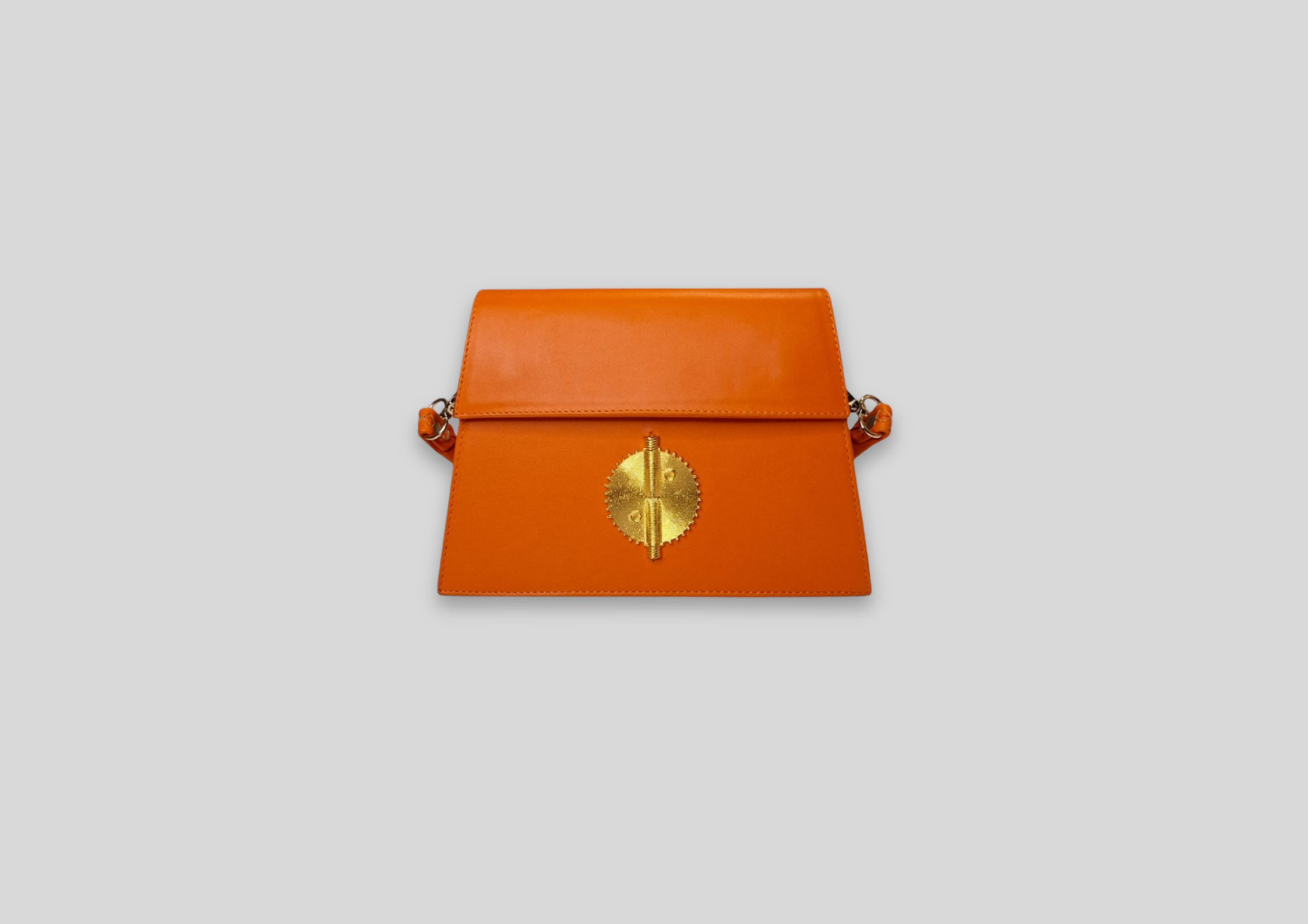 Malaika Bag in vibrant orange with gold detail, a luxury handbag perfect for special occasions and everyday elegance.